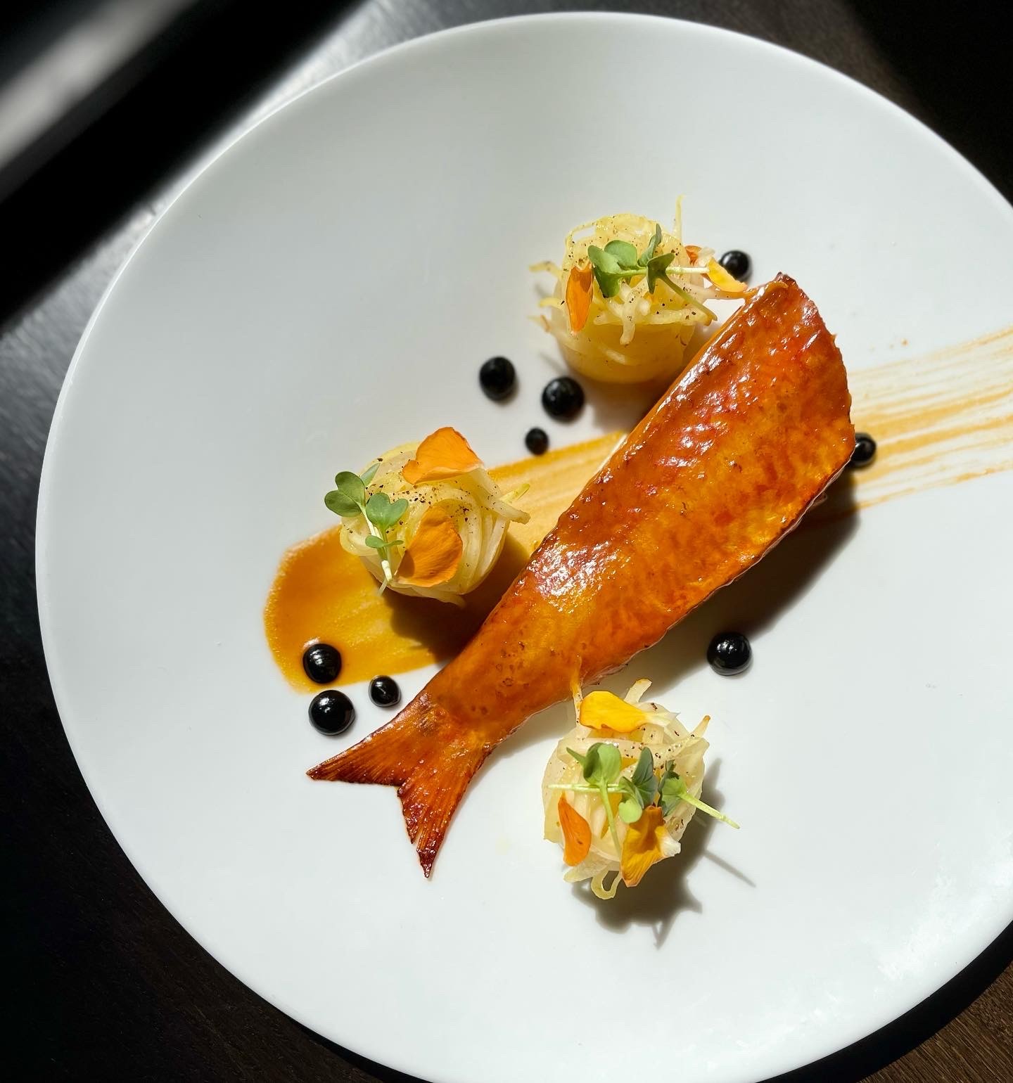 Glazed fish fillet with fennel salad and black pearls