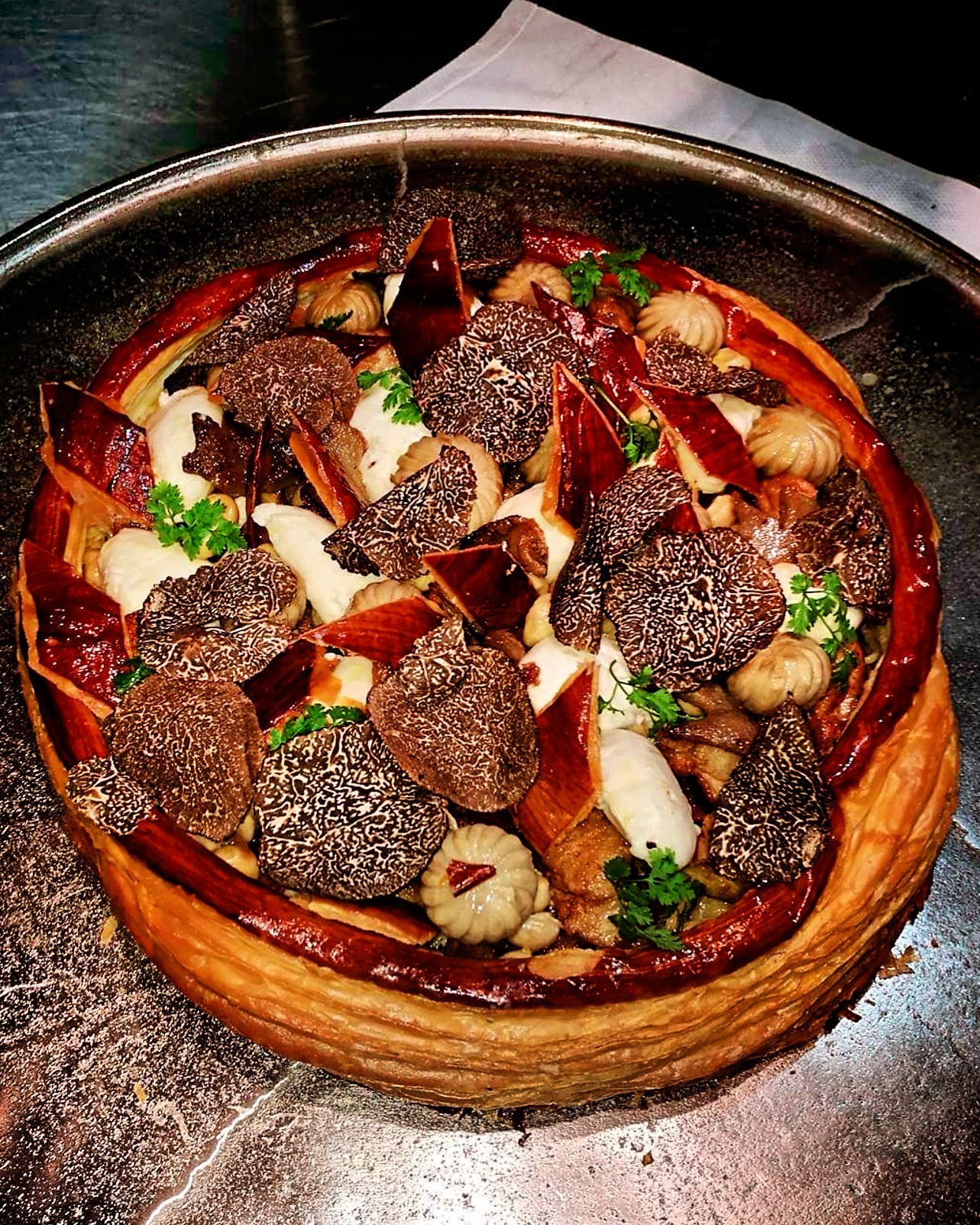 Puff pastry tart topped generously with shaved black truffle