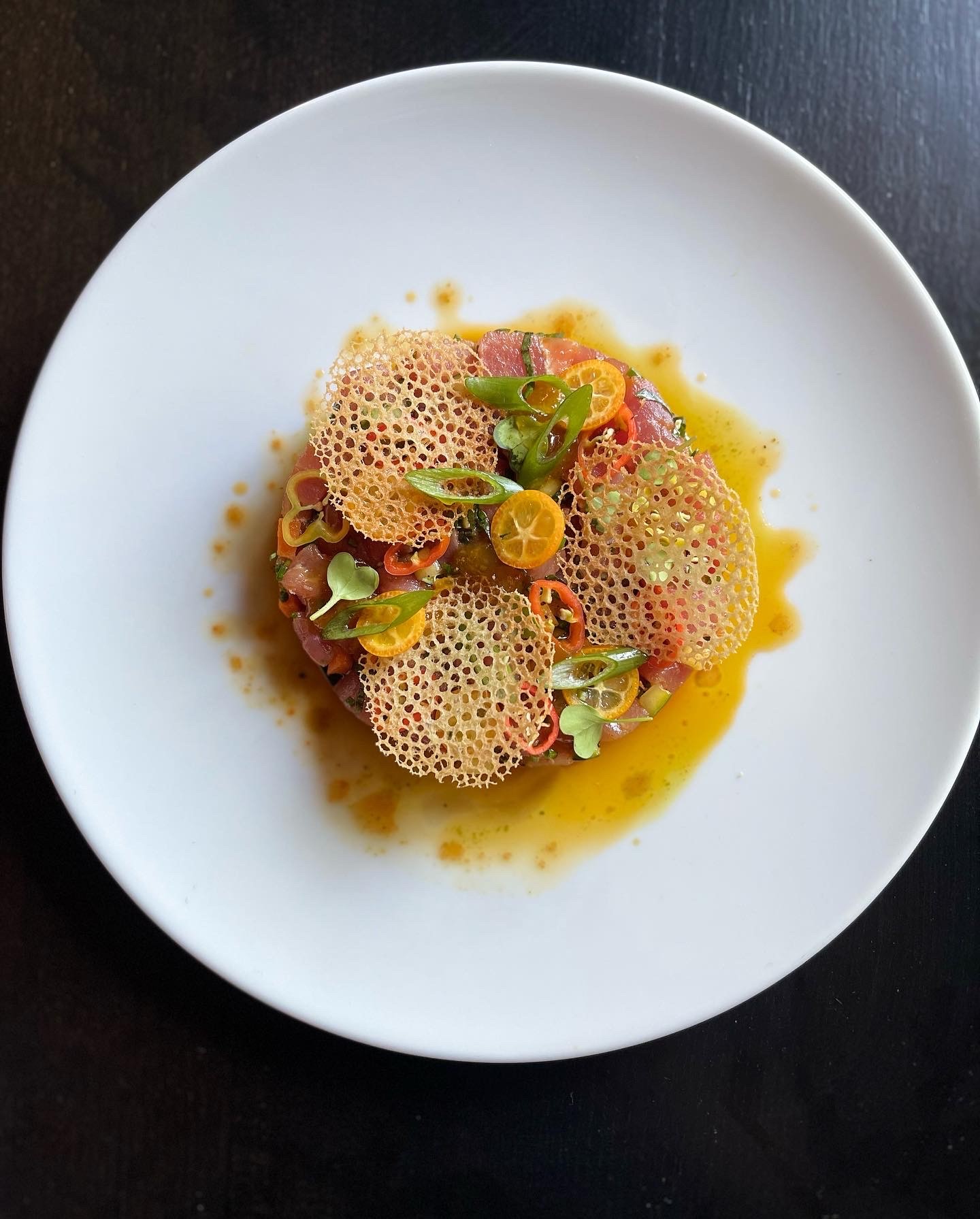 Tuna tartare with a crisp lattice tuile, kumquat and chili